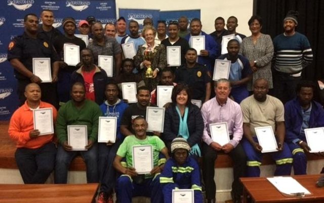 Executive Mayor Botha-Guthrie and Overstrand Municipality participants and volunteers proudly show off the certificates received as well as the trophy awarded to the winning touch rugby team at the Better Together Games